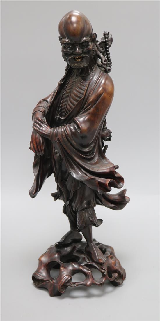 A late 19th/early 20th century Chinese hardwood figure of a luohan Height 43.5cm